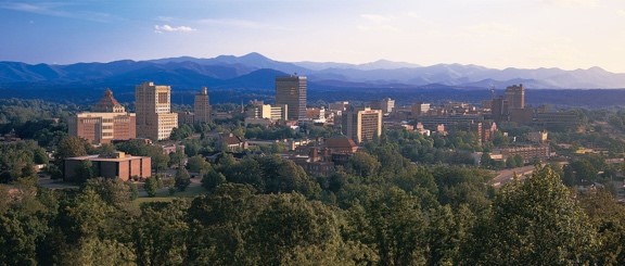 Aerial skyline of a city surrounded by trees